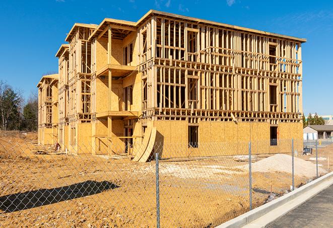 workers protected by temporary barrier fence during building maintenance in Cabazon